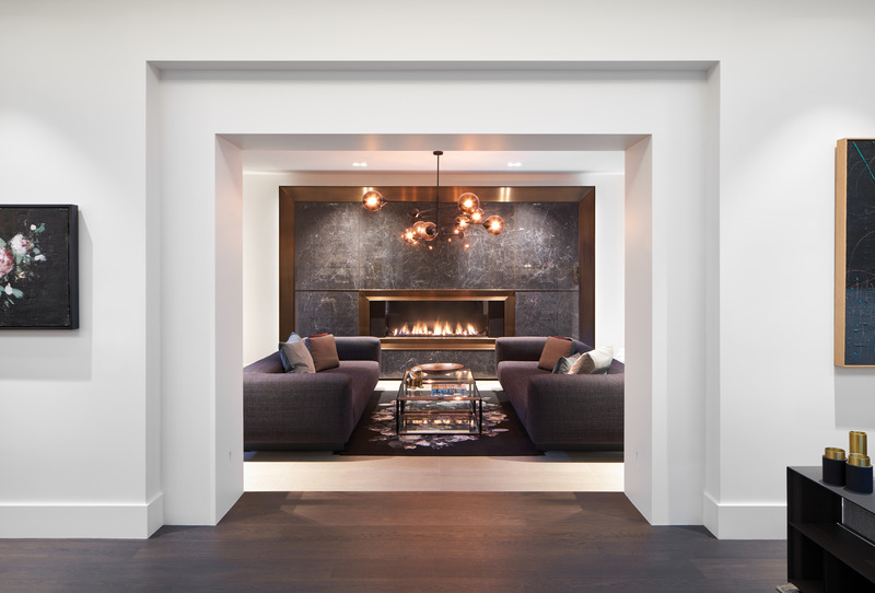 Press kit | 2941-03 - Press release | Annex Coach House - Taylor Smyth Architects - Residential Architecture - Linear gas fireplace is inset into a dramatic wall of dark veined stone trimmed in bronze. - Photo credit: Doublespace Photography Inc.