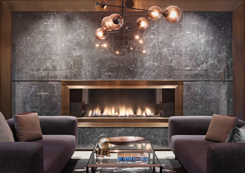 Press kit | 2941-03 - Press release | Annex Coach House - Taylor Smyth Architects - Residential Architecture - Linear gas fireplace is inset into a dramatic wall of dark veined stone trimmed in bronze. - Photo credit: Doublespace Photography Inc.