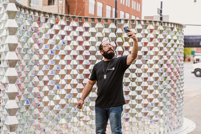 Press kit | 5595-02 - Press release | Ripple - The Urban Conga - Urban Design - Local Rochester resident getting the perfect selfie with the reflective backdrop.  - Photo credit: Savannah Lauren