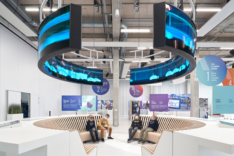 Press kit | 2845-02 - Press release | Institut des Mobilités et Transports Durables (IMTD) & Institut International du Management (IIM) - Université Polytechnique des Hauts-de-France (UPHF) - Coldefy - Institutional Architecture - The rotunda, the only fixed element of the exhibition forum, hosts a suspended video device showing an animated film on the evolution of mobility. - Photo credit: Epaillard Machado