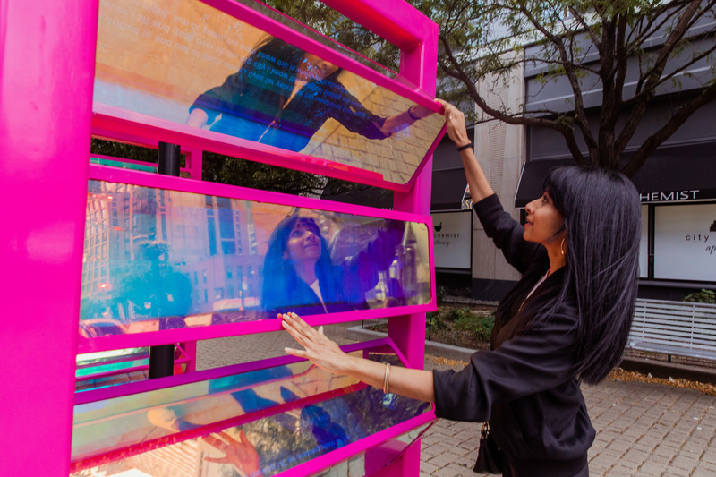 Press kit | 5595-03 - Press release | A Playful Gesture Designed to Evoke Communal Connection in Long Island City, NY - The Urban Conga & Hive Public Space - Art - This image shows a local resident playing with the reflections of the units.  - Photo credit: Savannah Lauren