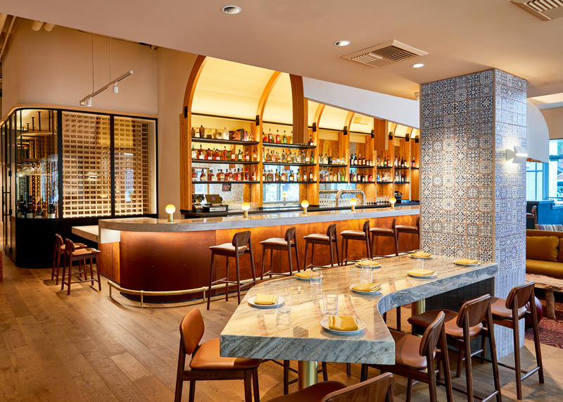 Press kit | 5857-02 - Press release | Studio UNLTD Designs  Callie Restaurant in San Diego to Compliment the Cuisine de Soleil - Studio UNLTD - Commercial Interior Design -  A blend of denim-blue decorative tiles adorn the columns in the dining room.   - Photo credit:  Lucianna McIntosh
