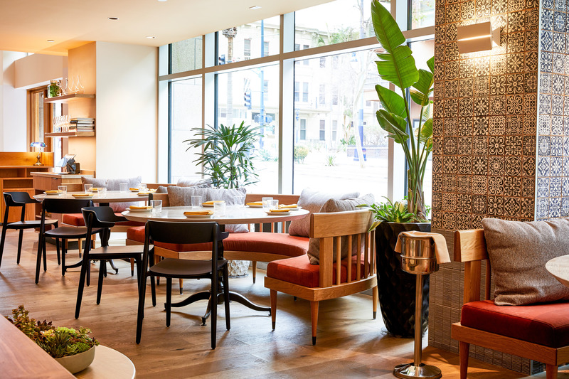Press kit | 5857-02 - Press release | Studio UNLTD Designs  Callie Restaurant in San Diego to Compliment the Cuisine de Soleil - Studio UNLTD - Commercial Interior Design - In the dining area, meandering seating has a relaxed, coastal feel, replete with plant life, marine blue chairs and rust colored booths.  - Photo credit:  Lucianna McIntosh 