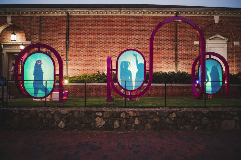 Press kit | 5595-05 - Press release | Art Museum Terrace Transformed into a Programmable Community Space - The Urban Conga - Landscape Architecture - A group can be seen striking a series of poses within the panels filling the archways.    - Photo credit: Tom Waldenberg