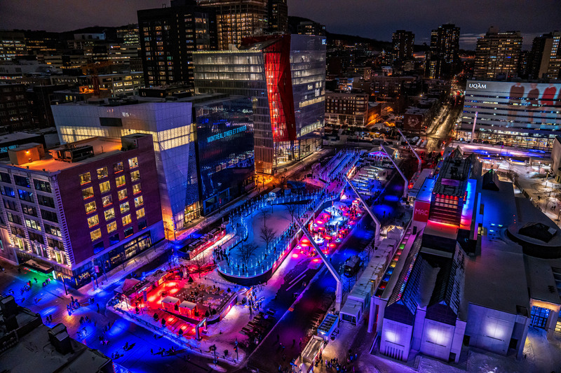 Press kit | 6776-01 - Press release | A Winter Experience Like no Other in the World. The Montréal en Lumière Festival Opens a 1000-Foot-Long Aerial Skating Trail with an Ambience of Immersive Sound and Light - Montréal en Lumière - Urban Design - <p>All the senses are engaged during the Skating Loop experience. On the elevated structure poised 2.5 meters above the ground, skaters are treated to a breathtaking view of the urban panorama, enhanced by large-scale video projections on the facades of surrounding structures, the Wilder Building and UQAM President Kennedy Pavilion. Hundreds of LED tube lights add extra enchantment to this icy course, while a state-of-the-art sound system broadcasts a playlist compiled just for the event throughout the site. </p> - Photo credit:  Victor Diaz Lamich for MONTRÉAL EN LUMIÈRE 