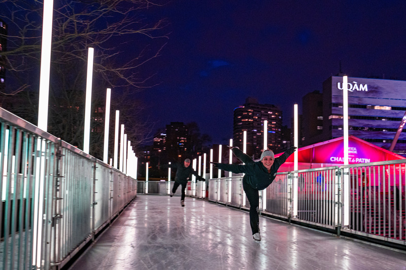 Press kit | 6776-01 - Press release | A Winter Experience Like no Other in the World. The Montréal en Lumière Festival Opens a 1000-Foot-Long Aerial Skating Trail with an Ambience of Immersive Sound and Light - Montréal en Lumière - Urban Design -   A figure skater glides along the 1000-foot-long path<br>   - Photo credit:    Victor Diaz Lamich for MONTRÉAL EN LUMIÈRE  