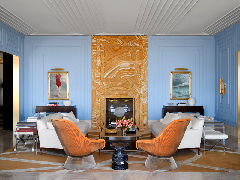 Press kit | 6087-03 - Press release | Family Connections: a Five-Star Retreat in the Desert Southwest - Daniel Joseph Chenin, Ltd. - Residential Interior Design -   Complementing a 12-foot-tall onyx double sided fireplace are two Platner Easy Chairs upholstered in a vibrant orange velvet.   - Photo credit: Douglas Friedman