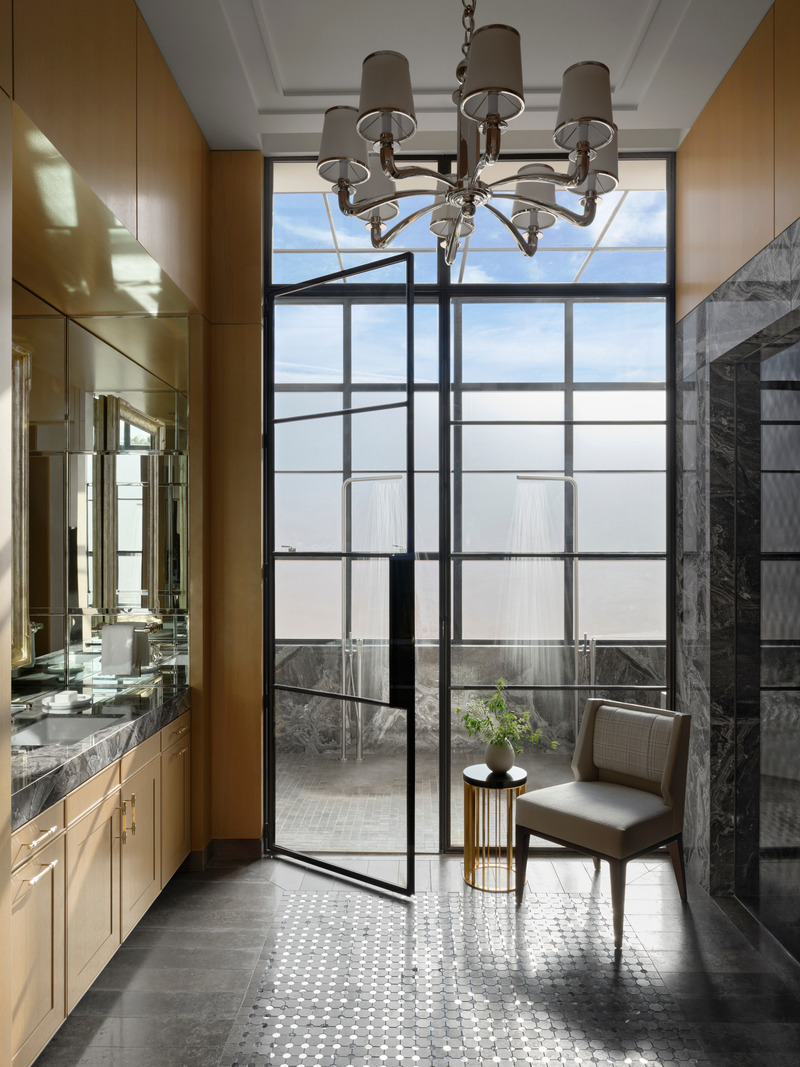 Press kit | 6087-03 - Press release | Family Connections: a Five-Star Retreat in the Desert Southwest - Daniel Joseph Chenin, Ltd. - Residential Interior Design - Dark detailing defines a more masculine bathroom, highlighted by a glassed-in outdoor shower that opens like a solarium, with operable windows and a glass roof that connects to the outdoors - Door Open. - Photo credit: Douglas Friedman