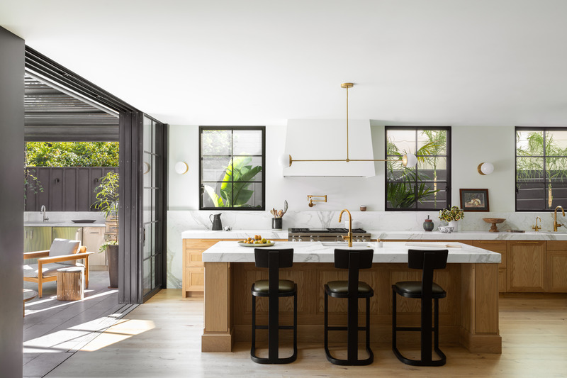 Press kit | 2757-35 - Press release | Medium Plenty Gives a Sprawling Update to a Once Modest 1920s Spanish Revival Home - Medium Plenty - Residential Interior Design - Sliding steel-and-glass doors disappear when open, connecting the kitchen directly to the terrace and backyard. - Photo credit:  Laure Joliet Photography 