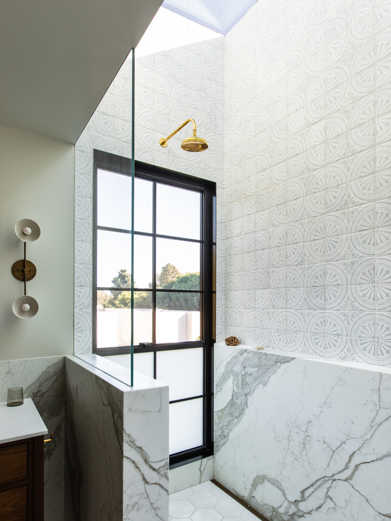 Press kit | 2757-35 - Press release | Medium Plenty Gives a Sprawling Update to a Once Modest 1920s Spanish Revival Home - Medium Plenty - Residential Interior Design -  Medium Plenty designed a full height window at the end of the shower that utilizes “switchglass” allowing the lower portion to toggle between clear and obscure.   - Photo credit:  Laure Joliet Photography 