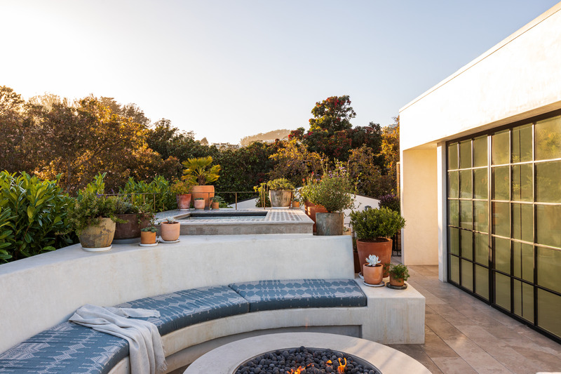 Press kit | 2757-35 - Press release | Medium Plenty Gives a Sprawling Update to a Once Modest 1920s Spanish Revival Home - Medium Plenty - Residential Interior Design - On the roof deck, which includes a hot tub, fire pit, and herb garden, Medium Plenty’s materials selections include tadelakt plaster, Zellige tile, unlacquered brass handrails and lilah grey stone. The firepit is by Concreteworks Tinder.  - Photo credit:  Laure Joliet Photography 