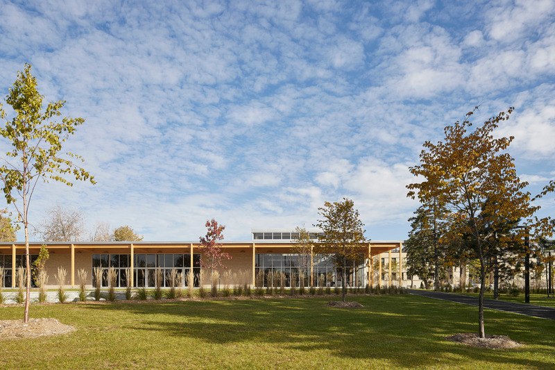 Press kit | 1640-01 - Press release | Territories and Landscapes Exhibition in Paris by Atelier Pierre Thibault - Atelier Pierre Thibault - Event + Exhibition -  <p>New pavilion for Collège Durocher (2022), Saint-Lambert, Montérégie<br></p><p>In the center of the existing main building, the old unused amphitheater has been completely renovated in order to renew the way of living in the College. This formerly obsolete, closed and opaque place has been decompartmentalized and redesigned to make it an open space, gathering, passage and transition, the Heart. The double height and the glazed hall let in plenty of light, which joins the wide bleachers at the very back. Small</p><p>modular study cabins allow you to work in groups of varying sizes. The sound of the place has also been studied to maintain a cozy atmosphere despite its size. Fabric acoustic panels and an angled wood slat ceiling were installed in the upper part to improve the reverberation of the double height and create an atmosphere conducive to both discussions and workshops.</p>  - Photo credit: Maxime Brouillet