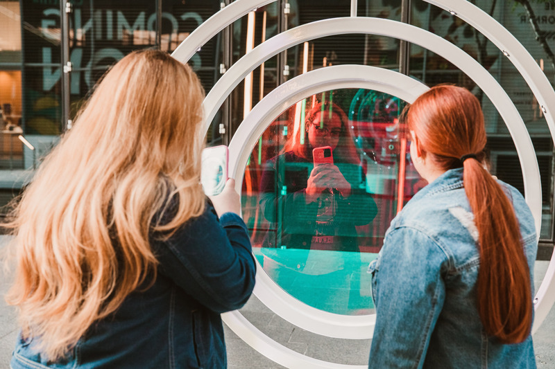 Press kit | 5595-08 - Press release | oPTIK, a New Interactive Sound and Light Installation in New York City - The Urban Conga - Art - The dichroic lens on oPTIK reflects and refracts the light creating a perfect color changing backdrop for a selfie.  - Photo credit: Savannah Lauren