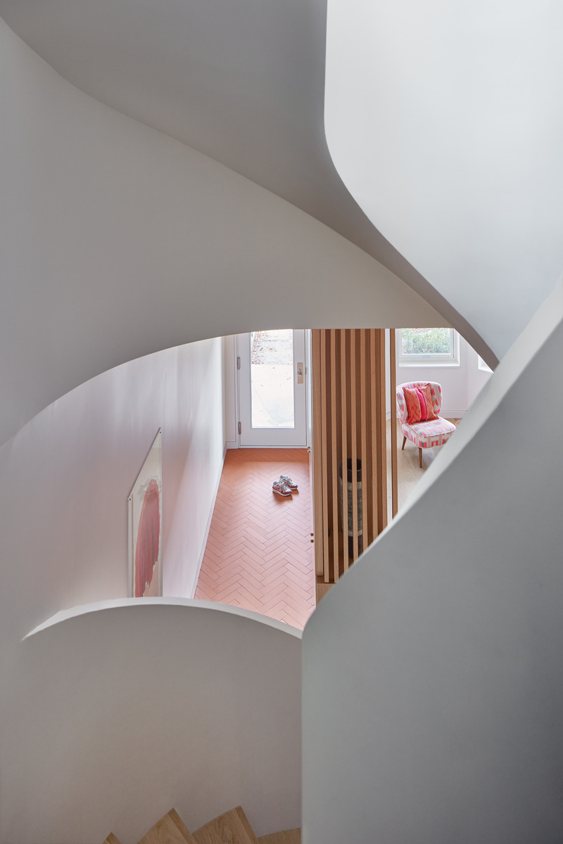 Dossier de presse | 1513-18 - Communiqué de presse | Flow House - Dubbeldam Architecture + Design - Architecture résidentielle - A glimpse of the entry foyer and living room below is framed by the undulating stair guards. - Crédit photo : Riley Snelling