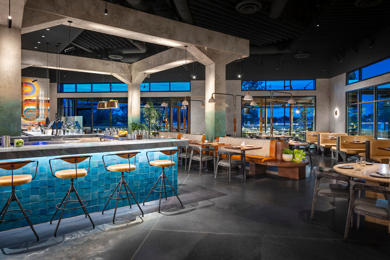 Press kit | 5857-03 - Press release | Saizon - Studio UNLTD - Commercial Interior Design - Heavily plastered columns and beams, reminiscent of decaying concrete pier supports add a dramatic gridded framework to the room while board-formed concrete wall tiles provide texture and depth. - Photo credit: Zack Benson Photography