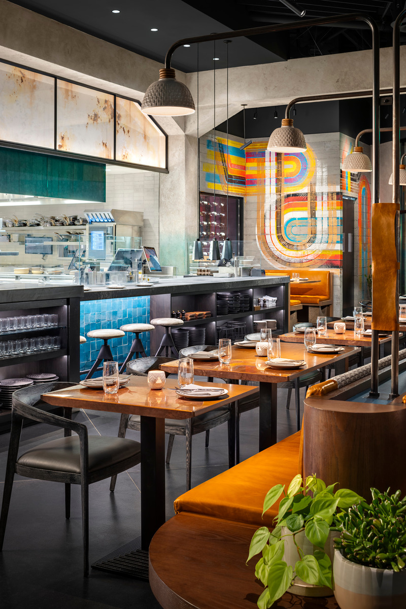 Press kit | 5857-03 - Press release | Saizon - Studio UNLTD - Commercial Interior Design - Custom armed pendants mounted along the spine of the double-sided banquette feature textured ceramic shades and leather strapping. - Photo credit: Zack Benson Photography