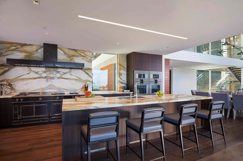 Press kit | 2757-38 - Press release | Swatt Miers Architects Serves Up California Cool with a Warm Modern Twist - Swatt Miers Architects - Residential Architecture - <p>  Drury Court Residence:   The kitchen features Calcatta Macchia Vecchia Polished stone from DaVinci Marble and stained German Oak wood floor with Trail/Spessart Oak wood casework veneers from Poliform.  The appliances from  Gaggenau, Miele, Subzero and Wolf and the range is La Cornue.</p> - Photo credit: Russell Abraham