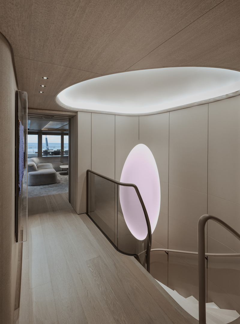 Press kit | 889-06 - Press release | BURDIFILEK Sets Sail Into the World of Luxury Yachting With Entourage - BURDIFILEK - Residential Interior Design - The staircase on main deck with its organic wall opening introduce a splash of color. - Photo credit: Guillaume Plisson