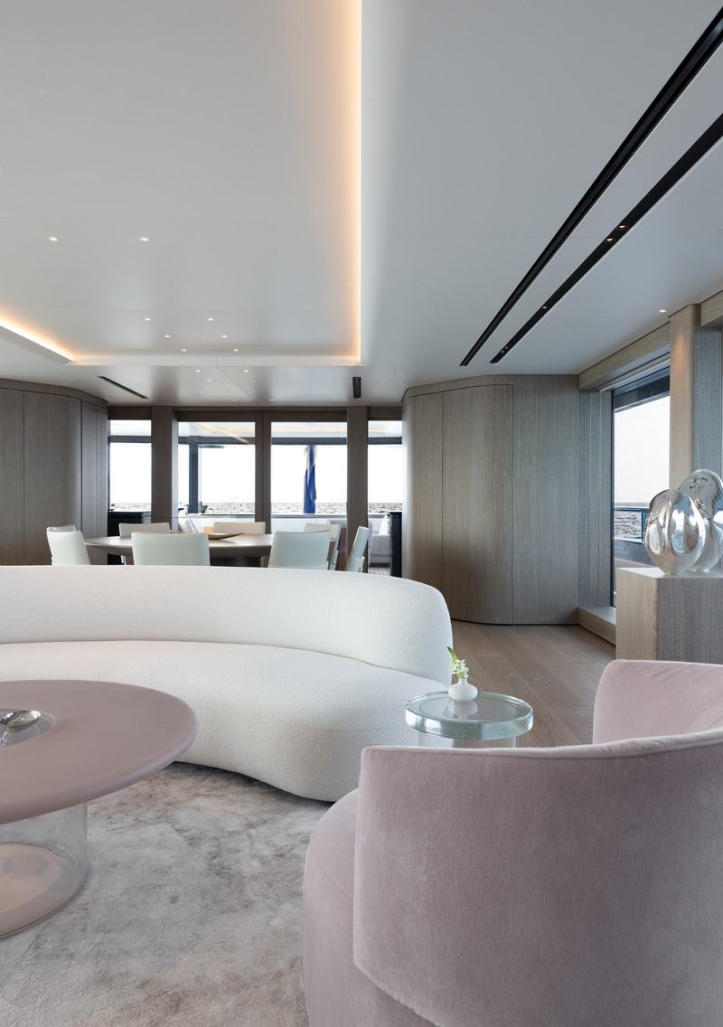 Press kit | 889-06 - Press release | BURDIFILEK Sets Sail Into the World of Luxury Yachting With Entourage - BURDIFILEK - Residential Interior Design - In the salon one is welcomed to thoughtfully curated furnishings with a hint of blush, sand-colored carpets, and fumed-oak wall finishes. - Photo credit: Guillaume Plisson