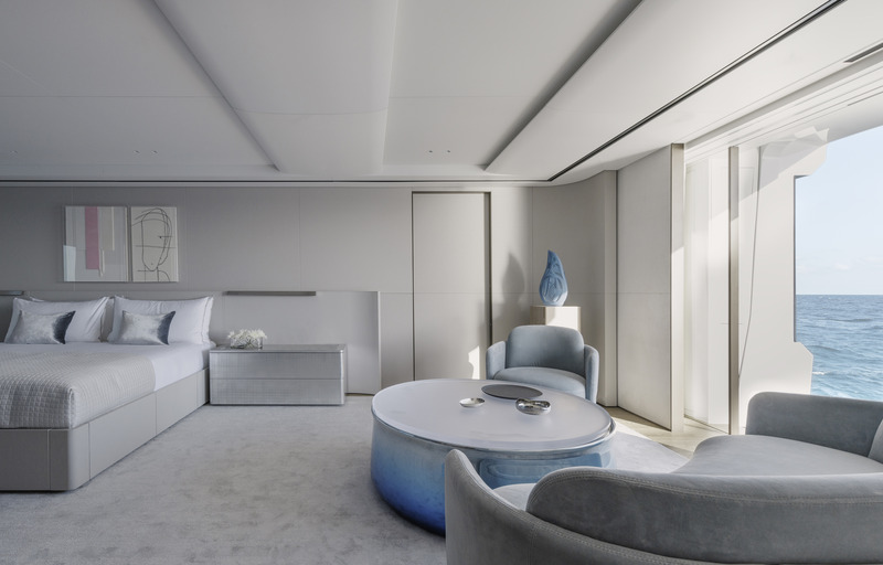 Press kit | 889-06 - Press release | BURDIFILEK Sets Sail Into the World of Luxury Yachting With Entourage - BURDIFILEK - Residential Interior Design - The stateroom’s sea view serves as a backdrop to the pastel, blue-toned furnishings. All furnishing was custom designed including the blue chrome and resin coffee table. - Photo credit: Guillaume Plisson