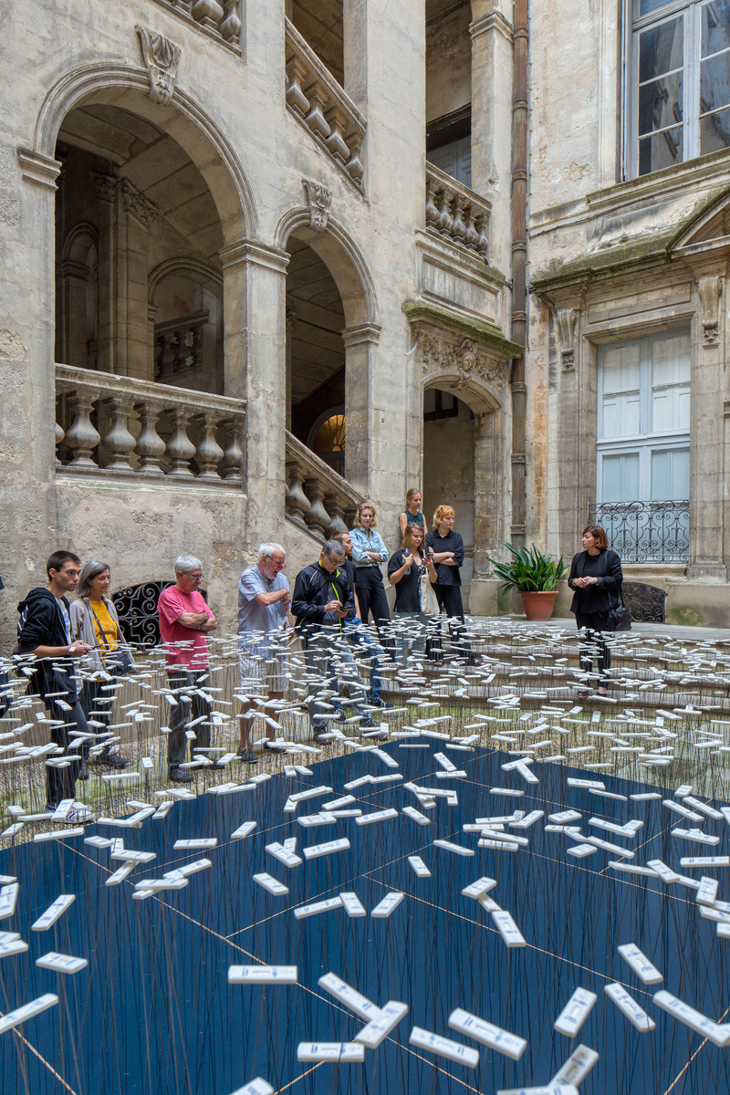 Dossier de presse | 7090-01 - Communiqué de presse | Les Fleurs de la Maladie : installation artistique des tests COVID-19 recyclés - Subset - Design urbain -  Expliquer l'installation aux visiteurs  - Crédit photo : Paul Kozlowski - Photoarchitecture