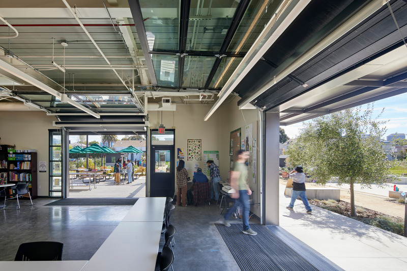 Press kit | 2757-41 - Press release | CAW Architects' Newest Educational Design for Oakland Unified School District Transforms Both Food Education and Distribution - CAW Architects - Commercial Architecture - <p class="">Through large glass roll-up doors, the classrooms flow directly onto the outdoor courtyard. </p> - Photo credit: Bruce Damonte Photography
