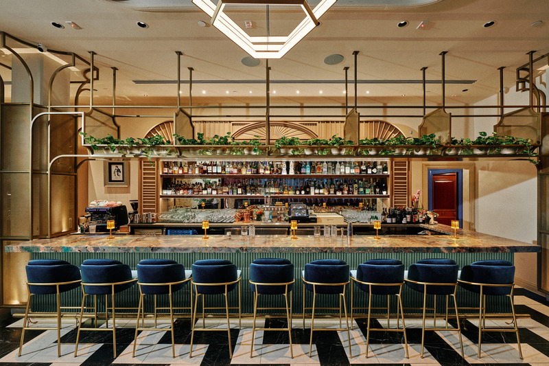 Press kit | 5857-04 - Press release | Studio UNLTD Unveils Design of Cino Restaurant - Studio UNLTD - Commercial Interior Design - Bar features include a ribbed bar face of teal-blue tile, amazonite marble bar top, decorative brass shelving and a slatted, baroque-inspired molding that arches over the back bar. - Photo credit: Chris Rohrer