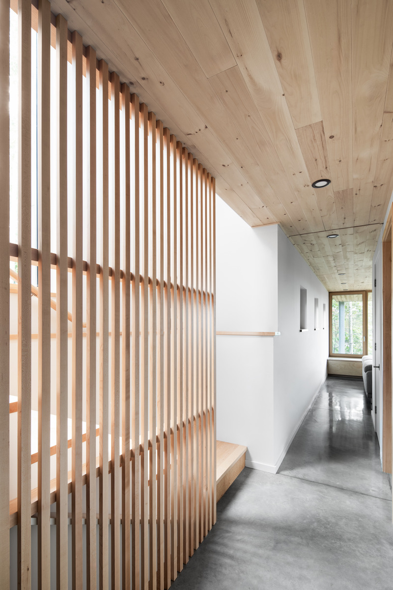 Dossier de presse | 2054-04 - Communiqué de presse | Chalet Papillon - RobitailleCurtis - Architecture résidentielle -  Vue de l'escalier et hall de l'étage inférieur; vue vers le Sud-Est et vers le salon/salle de jeux - Crédit photo : Adrien Williams