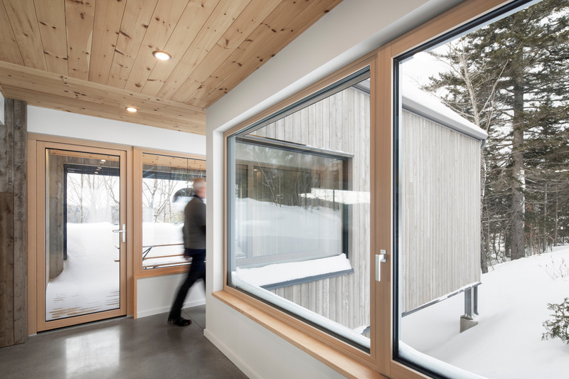 Dossier de presse | 2054-04 - Communiqué de presse | Chalet Papillon - RobitailleCurtis - Architecture résidentielle -  Vue depuis le hall d'entrée; vue vers l'Ouest du porche couvert et de la chambre principale - Crédit photo : Adrien Williams