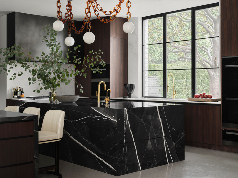 Press kit | 6087-05 - Press release | Palm Residence: A Harmonious Fusion of Hospitality and Home - Daniel Joseph Chenin - Residential Interior Design - Custom Cerine swagged chandelier by Trueing above the stone wrapped main island  serves as the focal point within the kitchen.  - Photo credit: Douglas Friedman