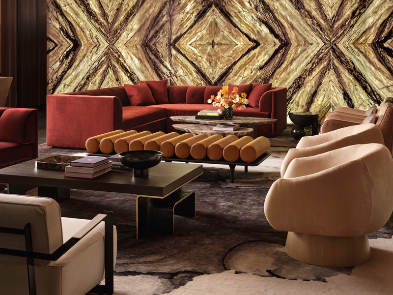 Press kit | 6087-05 - Press release | Palm Residence: A Harmonious Fusion of Hospitality and Home - Daniel Joseph Chenin - Residential Interior Design - Backlit onyx slabs set the tone for afterhours entertaining in the basement level lounge.  Scuptural furnishings including the Soho swivel chair by Una Malan, stone top Ledge coffee tables by DeMuro Das, and Profiterole coffee table byTwentieth are grounded by a custom area rug by The Rug Company. - Photo credit: Douglas Friedman