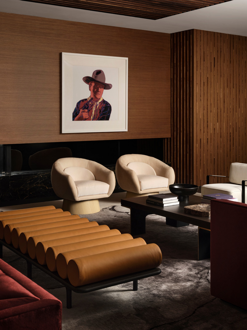 Press kit | 6087-05 - Press release | Palm Residence: A Harmonious Fusion of Hospitality and Home - Daniel Joseph Chenin - Residential Interior Design - Andy Warhol screen print depicting John Wayne hangs above the wood wrapped fireplace in the basement level lounge.  - Photo credit: Douglas Friedman