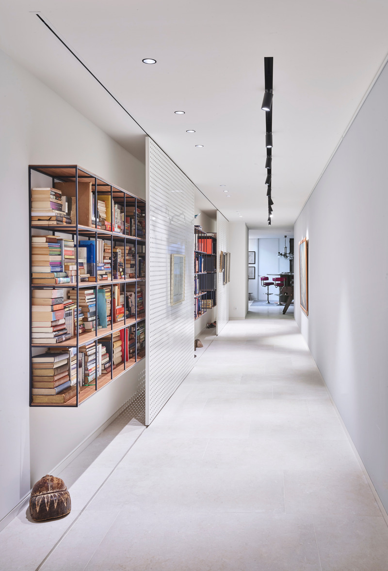 Press kit | 2757-44 - Press release | SWATT + PARTNERS' Eloquently Modern Architecture Lives Well in Singular Settings - SWATT + PARTNERS - Residential Architecture -  Casa Athena: For this elegant hallway, Swatt+Partners created a movable wall that hides portions of the built-in library from view.  - Photo credit: Jose Hevia