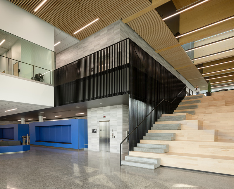 Press kit | 3253-05 - Press release | The Saint-Georges Multisport Complex: Bright and Welcoming - ABCP architecture in consortium with MLL et BBL architects - Institutional Architecture - With its tiered seating configuration, the wooden stepped staircase in the hall encourages social interactions, - Photo credit: Stéphane Groleau