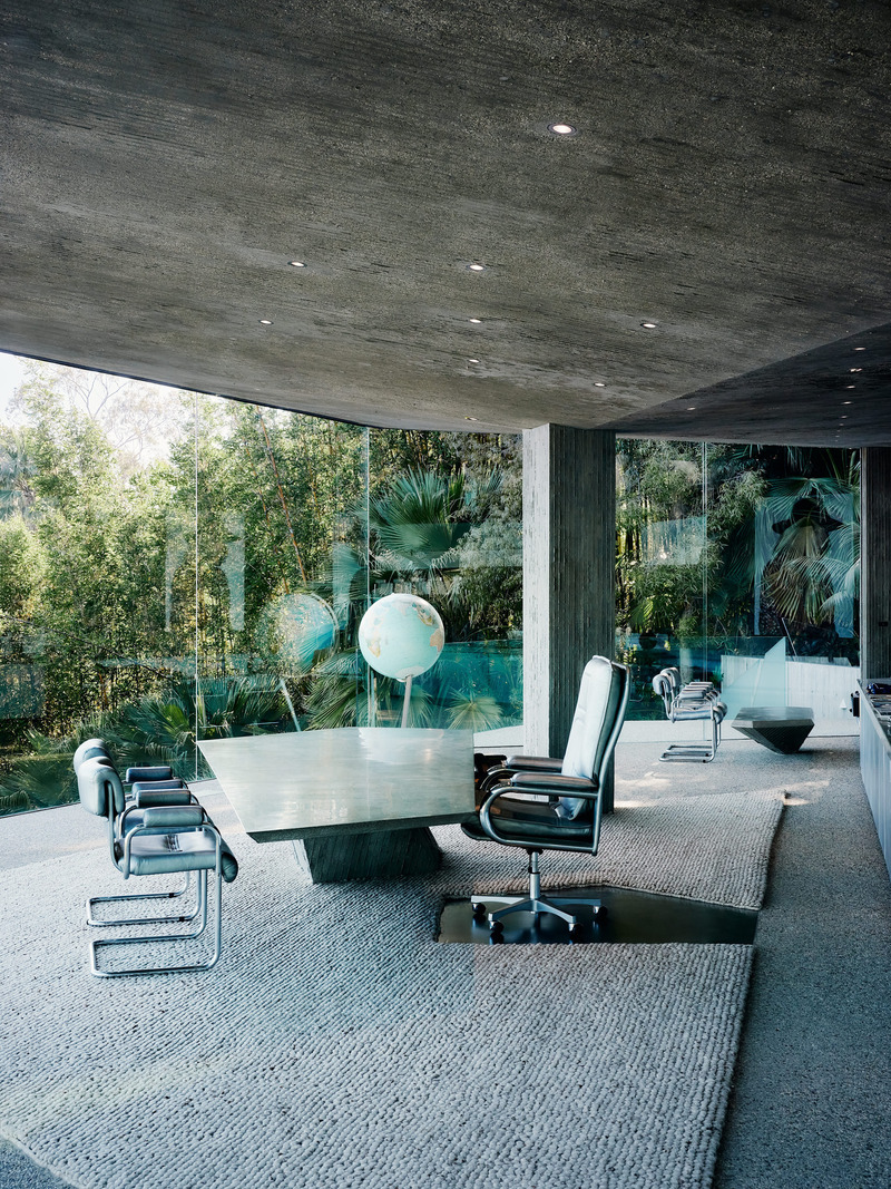 Dossier de presse | 2757-45 - Communiqué de presse | Honoring Architectural Lineage: Conner + Perry Architects Usher in a New Phase for an LA Landmark - Conner + Perry Architects - Architecture résidentielle - <p class=""><b>Offices:</b> Goldstein’s office is located at the southwest corner of the building and features a unique canted frameless glass enclosure that heightens the dramatic sense of the space pushing out into the view beyond. A custom cantilevered concrete desk dominates the room providing a spectacular perch from which to look out on the city. Custom stainless-steel shelves and built-in concrete and leather cabinetry house basketball memorabilia and photographs of Goldstein with a variety of celebrity friends.</p><p class=""><br></p><p class="">Behind (Off-Camera, Right) are the offices of Goldstein’s assistants, featuring glass clerestories and custom built-in concrete and leather office furniture.</p> - Crédit photo : Joe Fletcher Photography