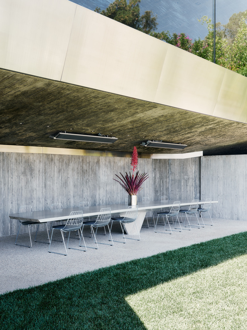 Dossier de presse | 2757-45 - Communiqué de presse | Honoring Architectural Lineage: Conner + Perry Architects Usher in a New Phase for an LA Landmark - Conner + Perry Architects - Architecture résidentielle - <p class=""><b>Lower Terrace Formal Dining:</b> Below the club and offices is the outdoor entertainment terrace, which features multiple dining areas each with dramatic concrete tables.  The table in the formal dining area is an engineering marvel, its slender profile cantilevering approximately 11 feet in both directions from a single tapered center support.</p> - Crédit photo : Joe Fletcher Photography